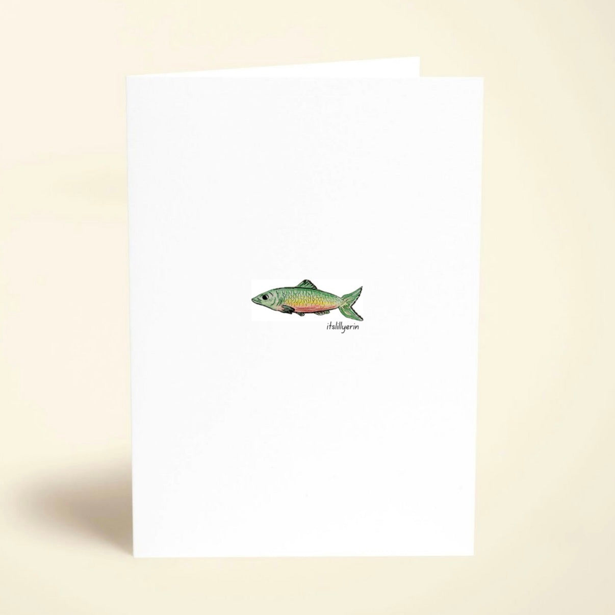 Note card with a fish illustration on a beige background
