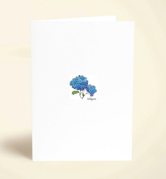 Note card with blue hydrangea design on a beige background