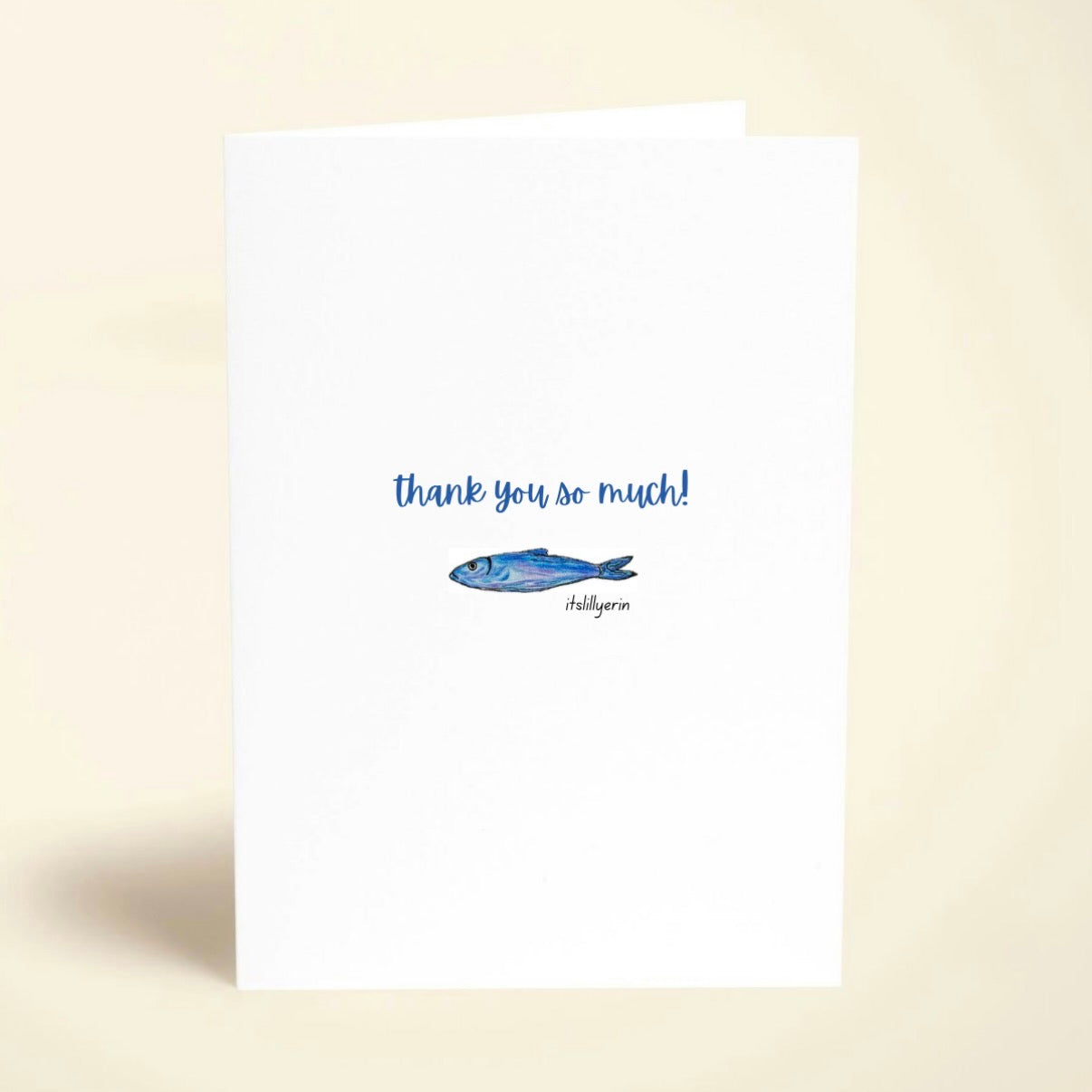 Note card with blue fish illustration and 'thank you so much!' text on a beige background