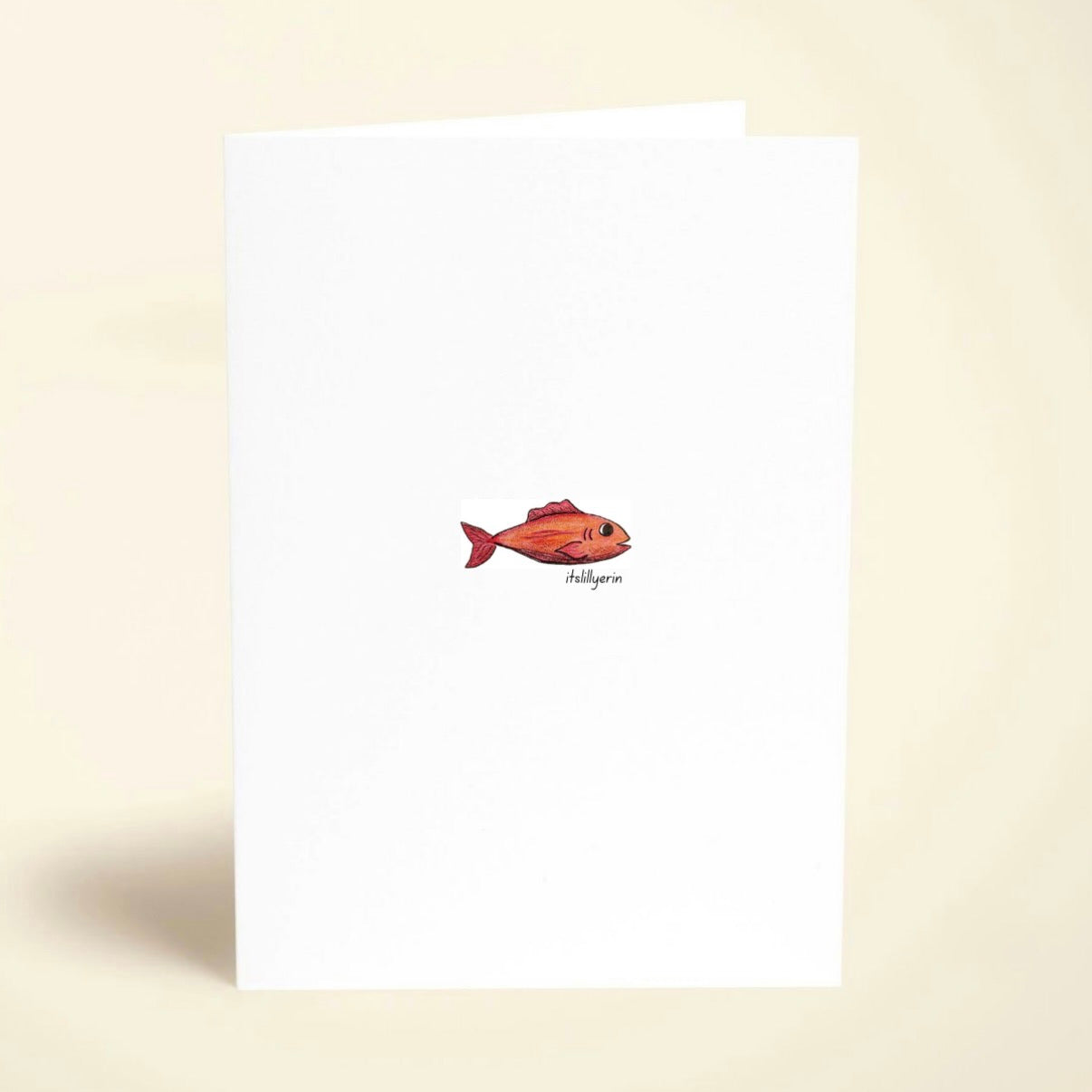 Note card with a red fish illustration on a beige background
