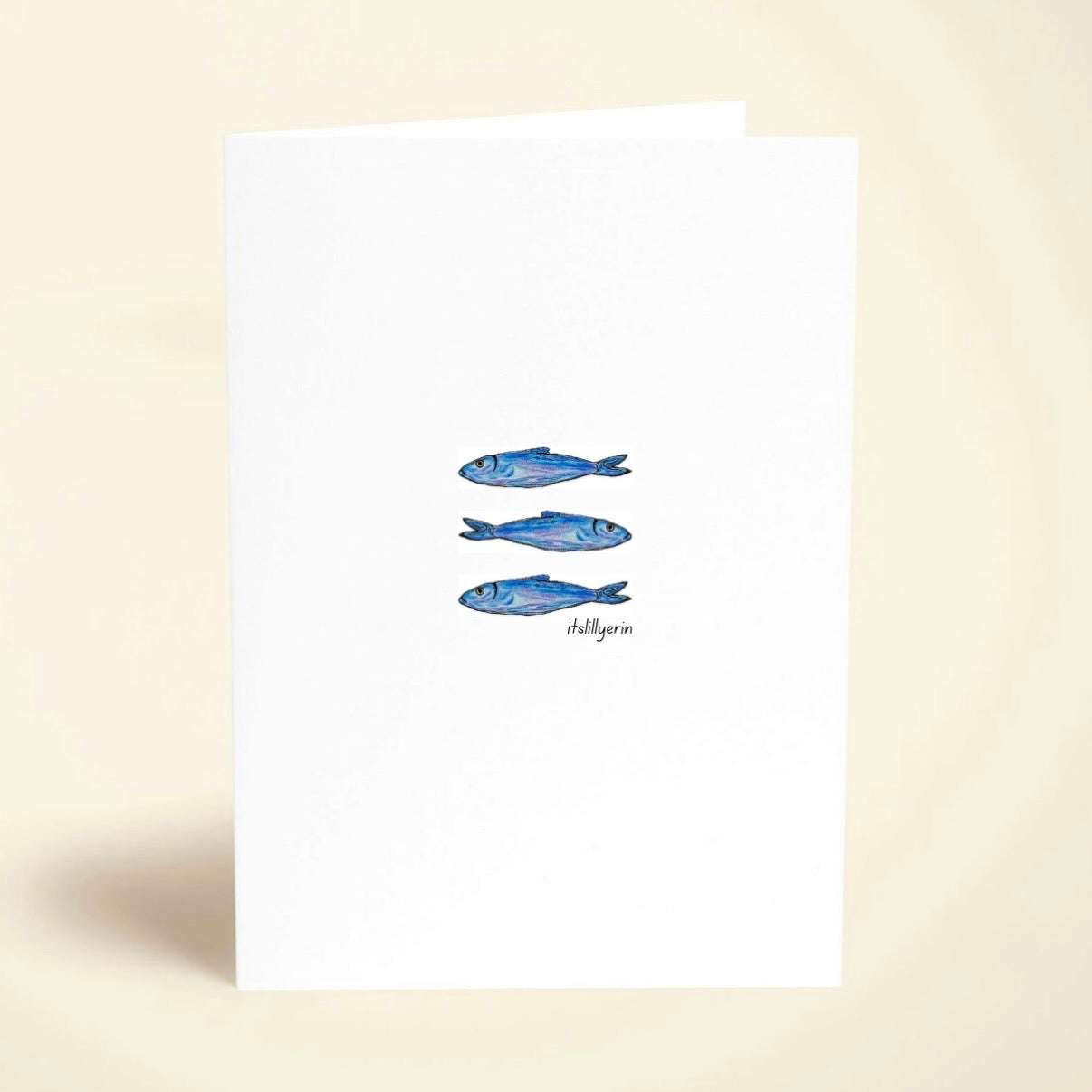 Note card with blue fish illustrations on a white background