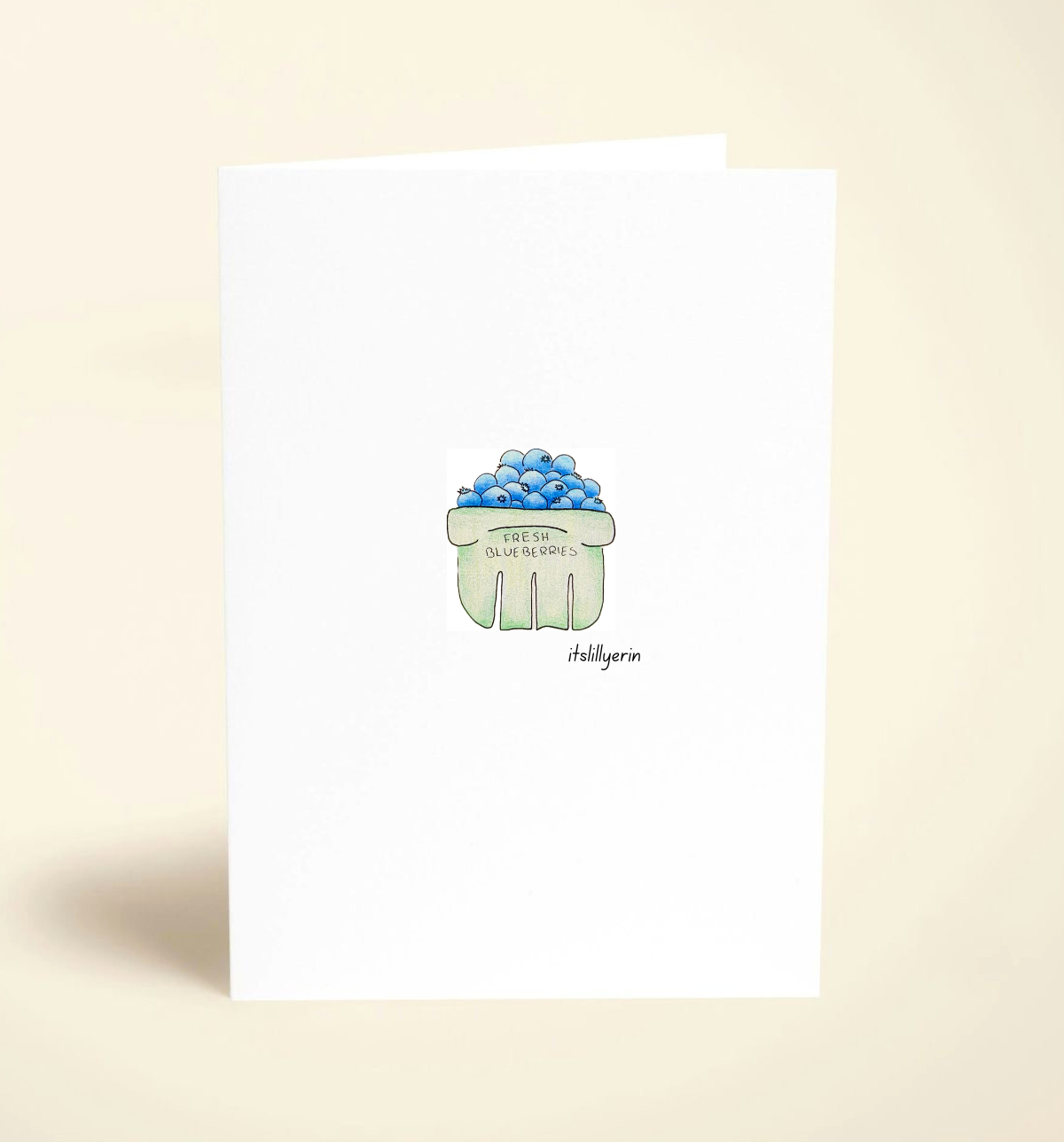 Note card with a green cupcake illustration on a beige background
