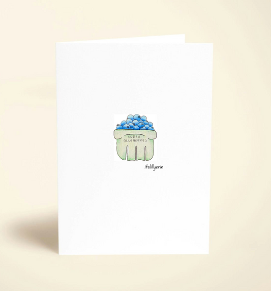 Note card with a green cupcake illustration on a beige background