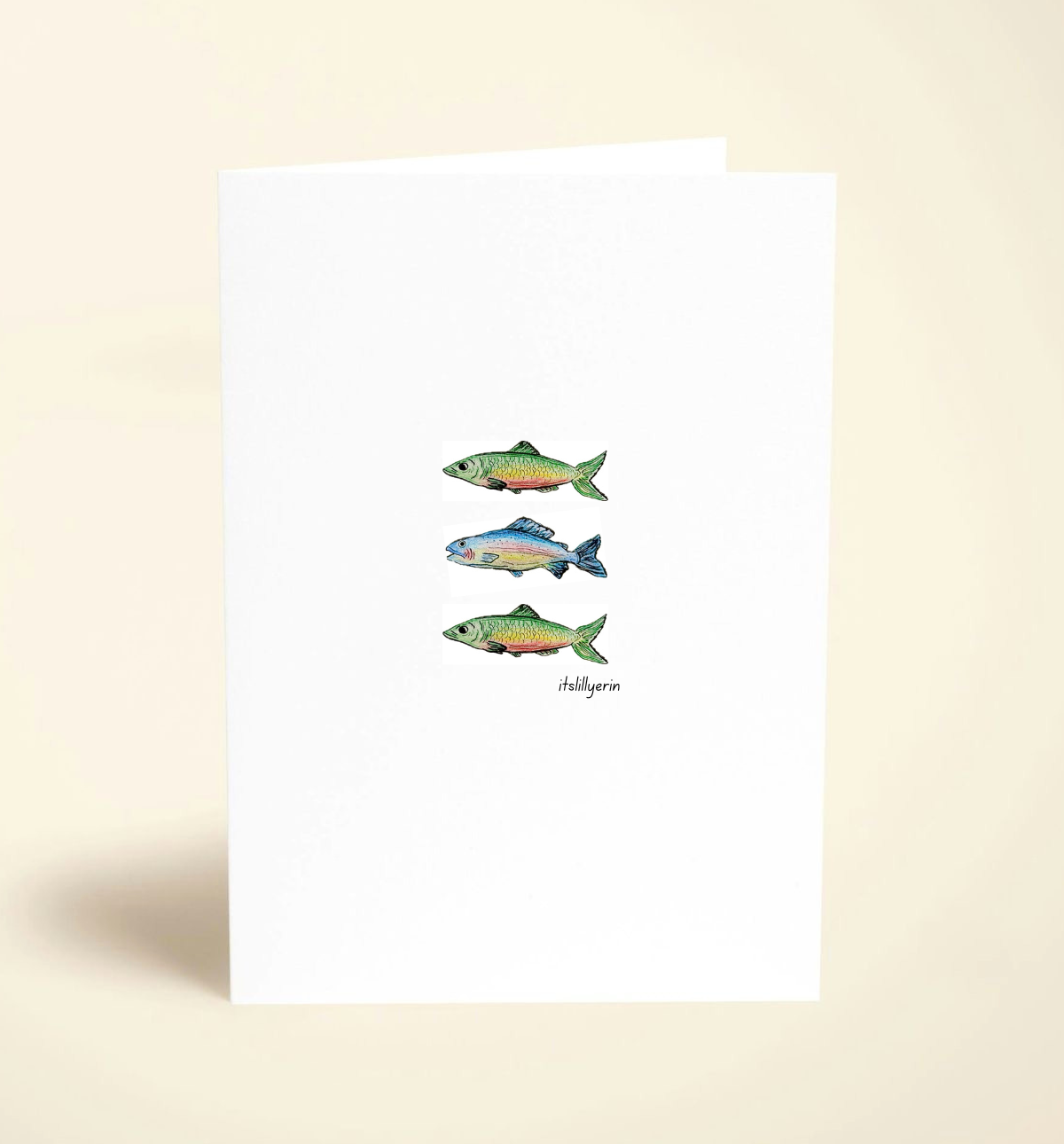 Note card with illustrations of three fish on a beige background
