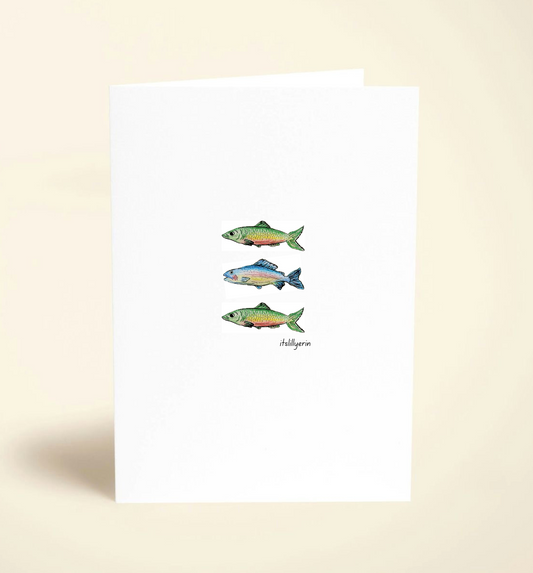 Note card with illustrations of three fish on a beige background